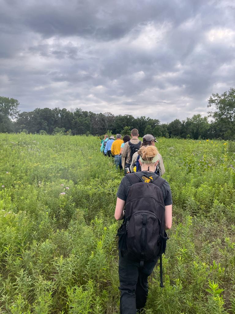 Volunteers hiking in the prairie during a workday